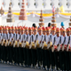 Thai royal guards with traditional drums march during the rehearsal of the coronation procession.